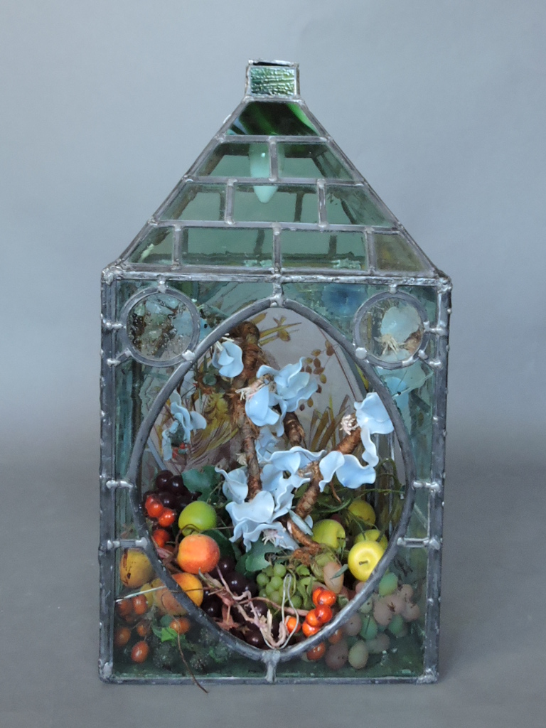 A Victorian and later lead-glazed terrarium, filled with artificial fruit and foliage, the main