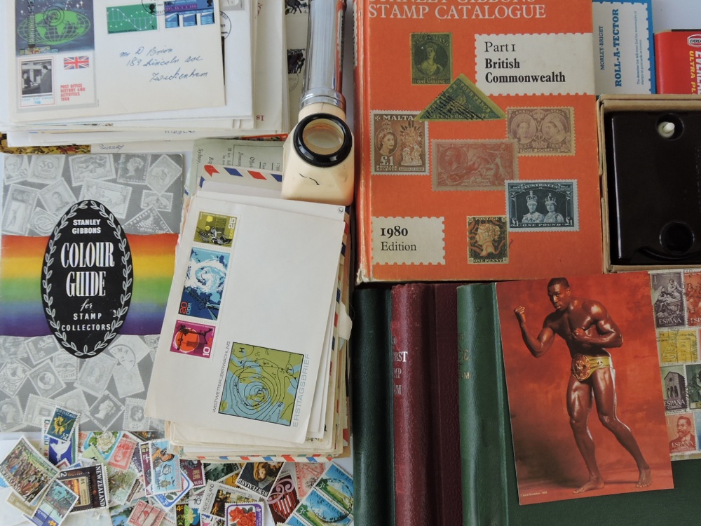 A collection of stamp albums, first day covers and associated equipment including 20th century