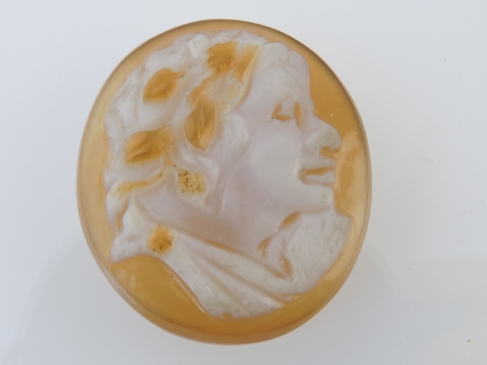 A unmounted cameo, amber-coloured, H. 2.5cm