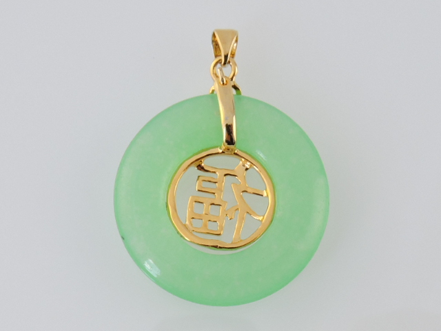 A jade and yellow metal mounted pendant, the opaque disc with characters within.
