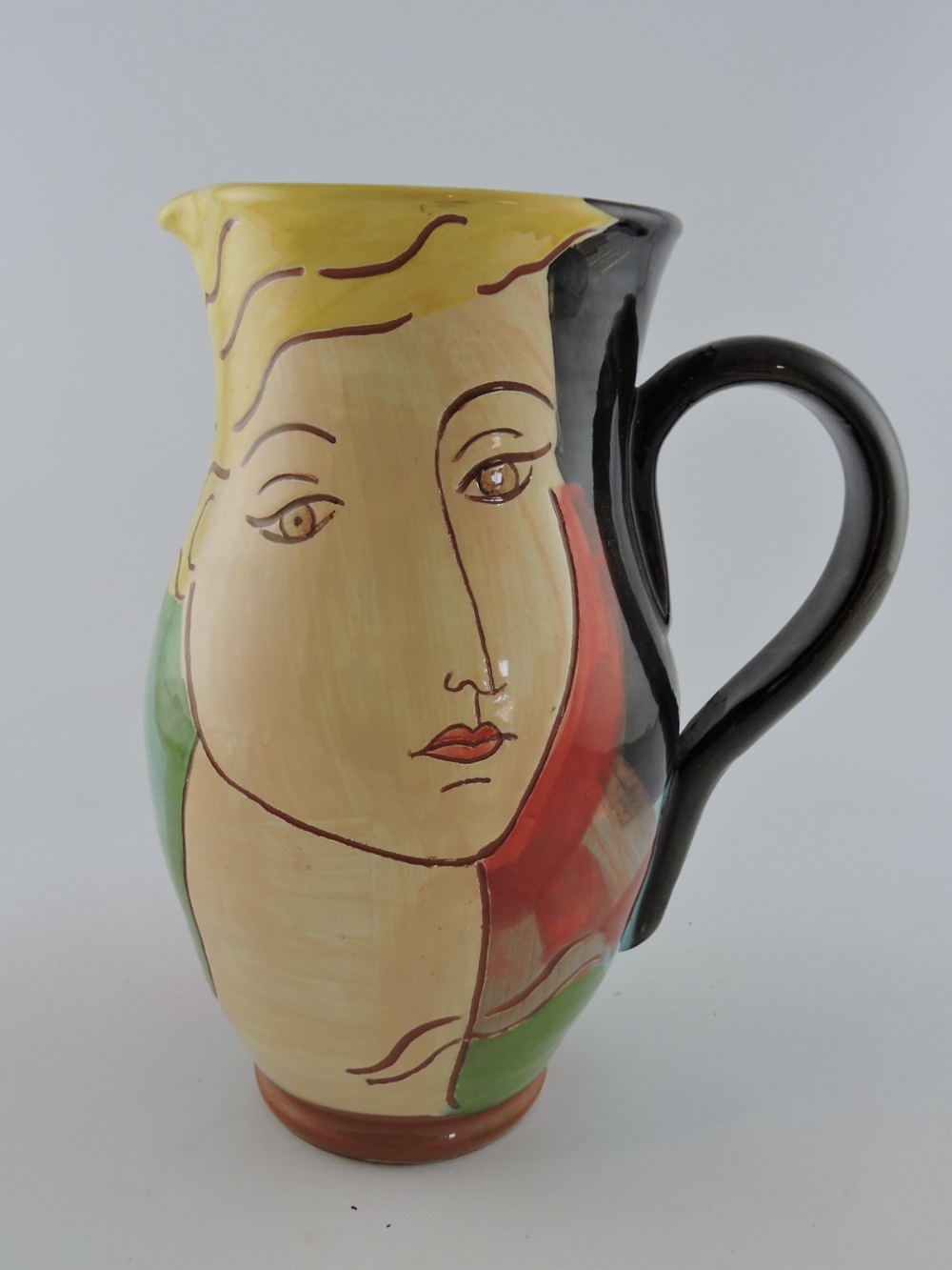 'Kay' a polychrome glazed studio pottery jug sgraffito baluster body decorated with female profiles,