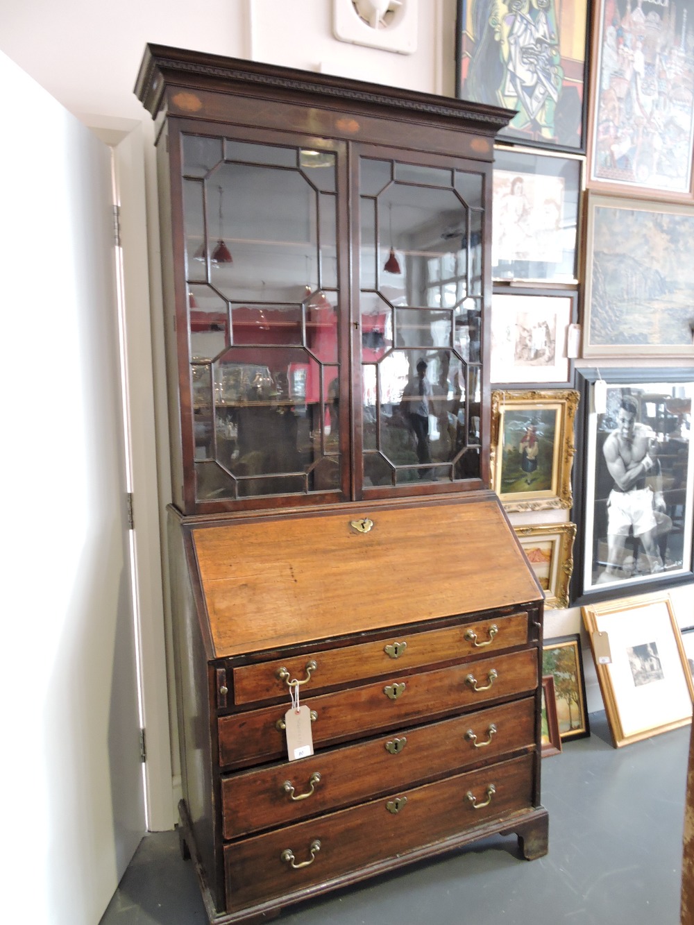 A George III mahogany bureau bookcase, the later glazed top with inlaid satinwood paterae over