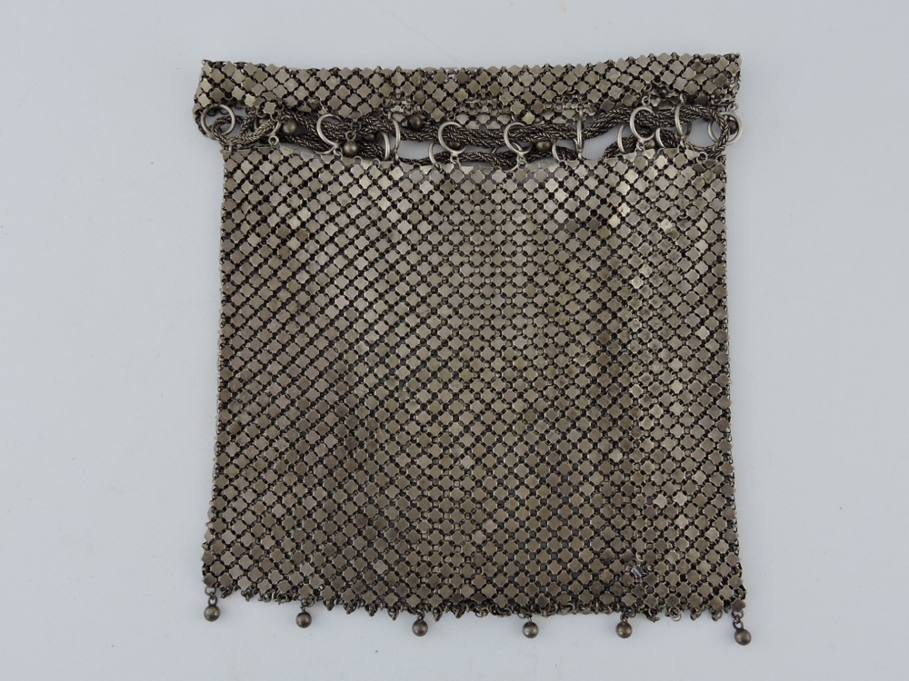An early 20th century Continental white metal evening bag, the drawstring above fringe terminating