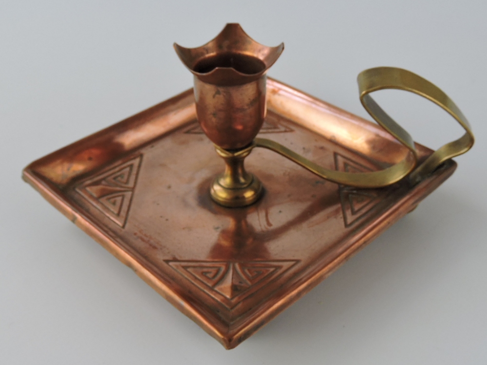 A late 19th century Continental copper Arts & Crafts chamber stick, by Carl Deffner, the square