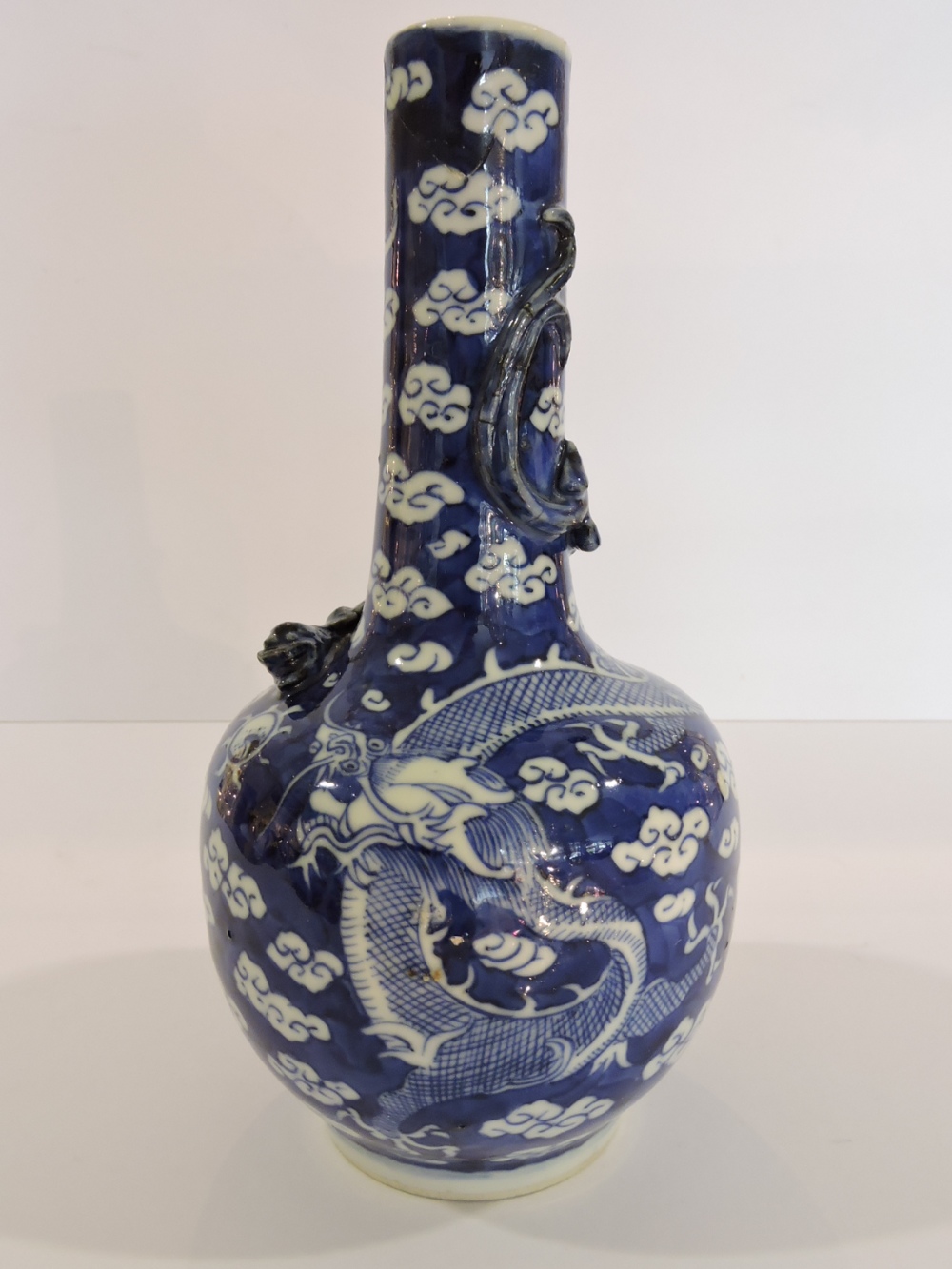 A 19th Century Chinese blue and white vase with serpent moulded neck painted with dragon and