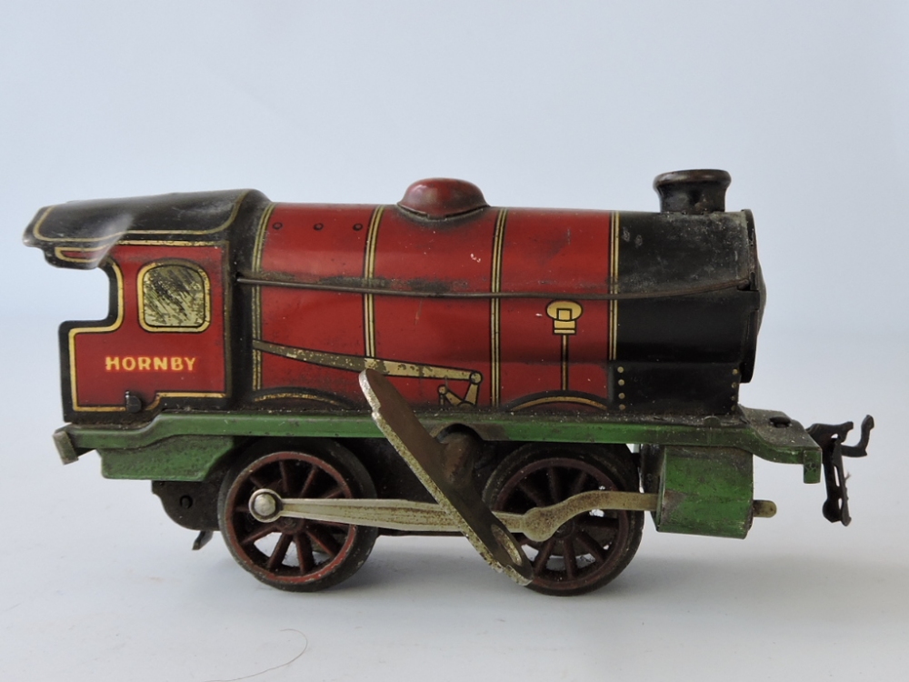 A Hornby 0-gauge clockwork 0-4-0 locomotive, in maroon livery, with key.