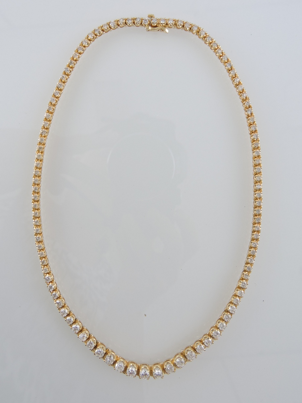 A 14ct yellow gold diamond-set necklace, the 103 collet set stones graduating from 0.04ct to 0.