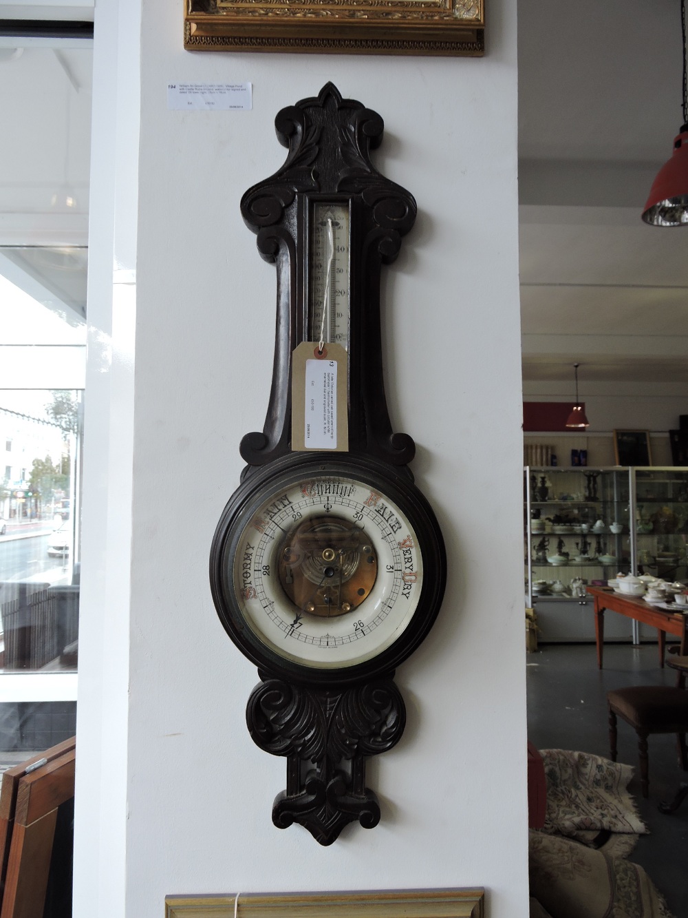 A late Victorian carved oak cased aneroid banjo barometer / thermometer with circular white