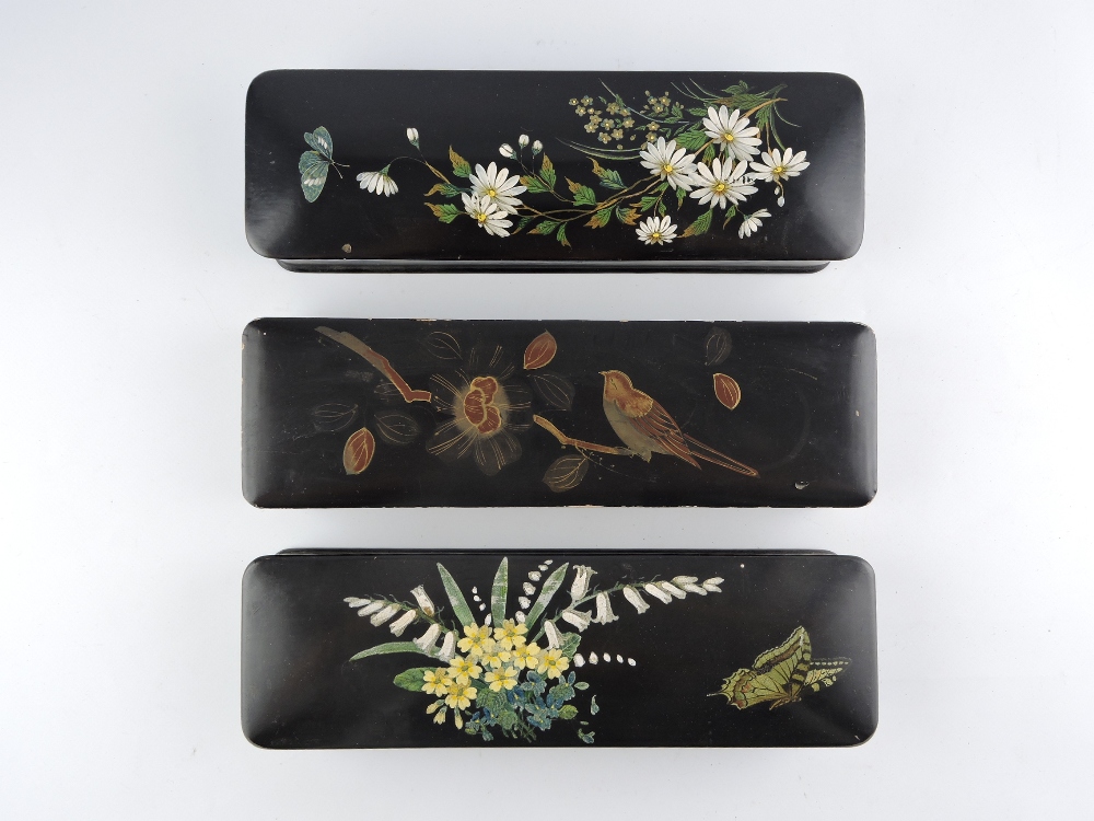 Two late Victorian rectangular papier-mache glove boxes decorated with butterflies among flowers,