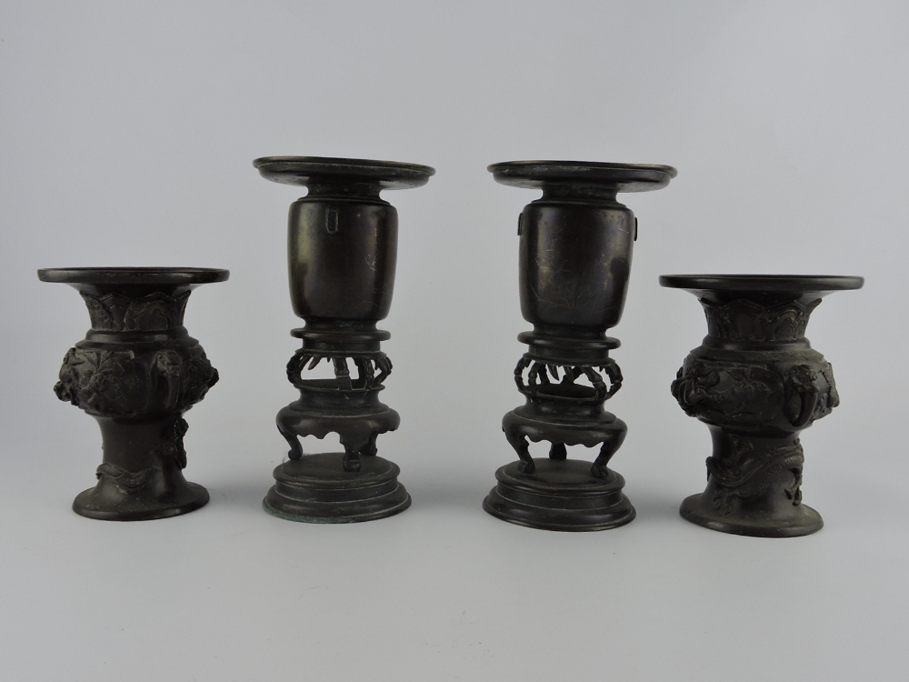 A pair of Chinese Meiji period bronze vases on stands cast with stylised birds, animals and blossom,