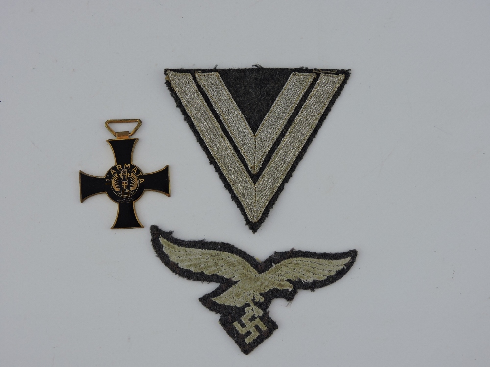 A pair of German Afrika Korps cloth badges, together with an Italian 11th Army brass and black