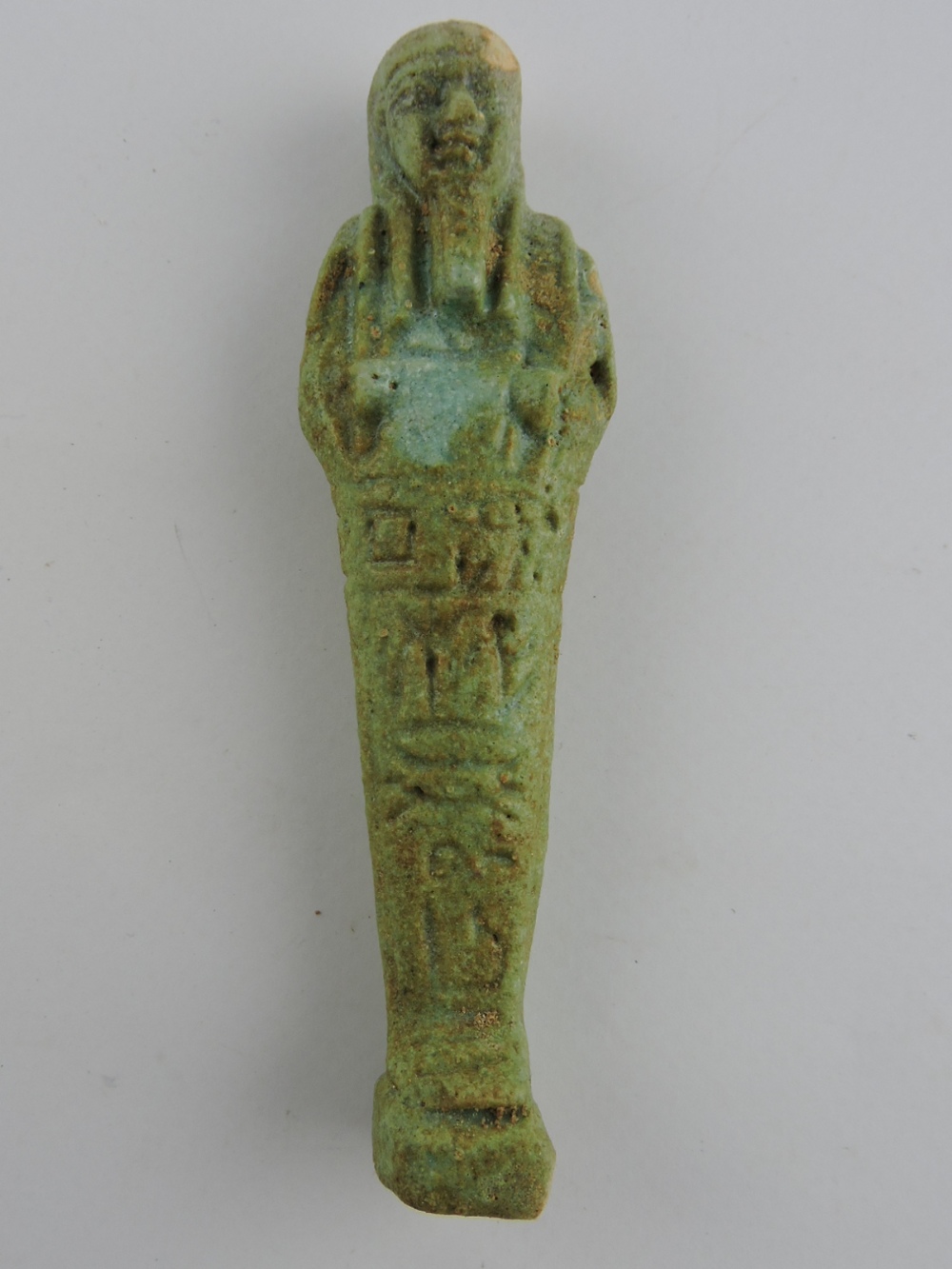 An Egyptian glazed pottery shabti, circa 500 BC, H. 10.5cm.