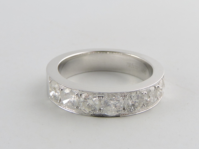 A seven-stone diamond half-eternity ring, in 18ct white gold channel setting, 1.29cts.
