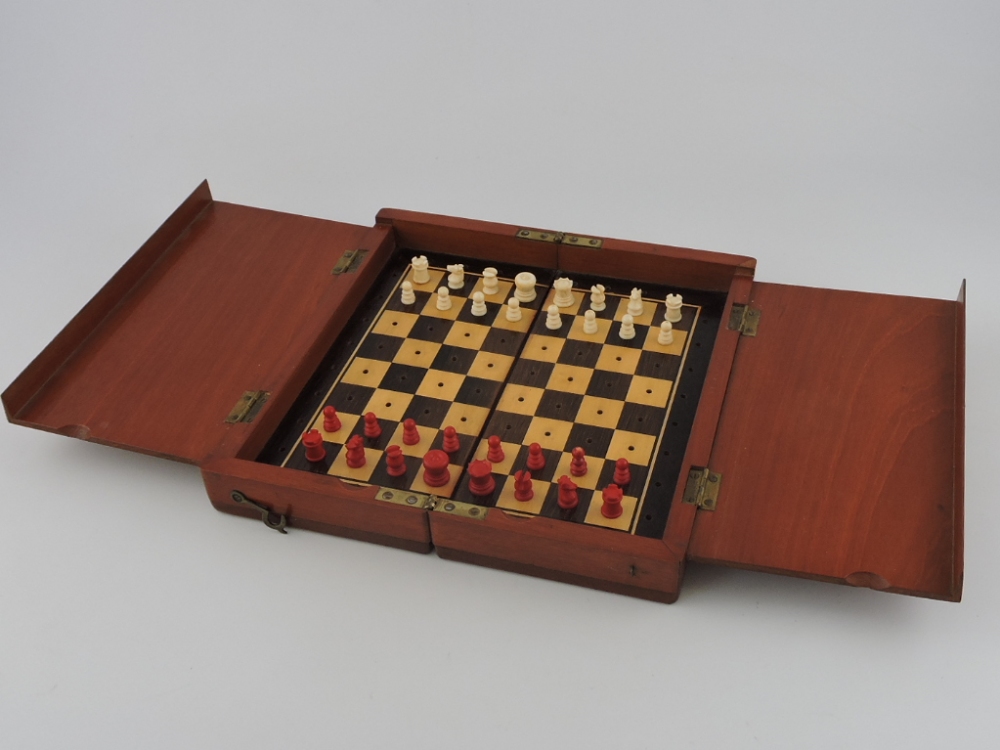 A late 19th century mahogany travelling chess set, in the manner of Jacques, the bone pieces stained