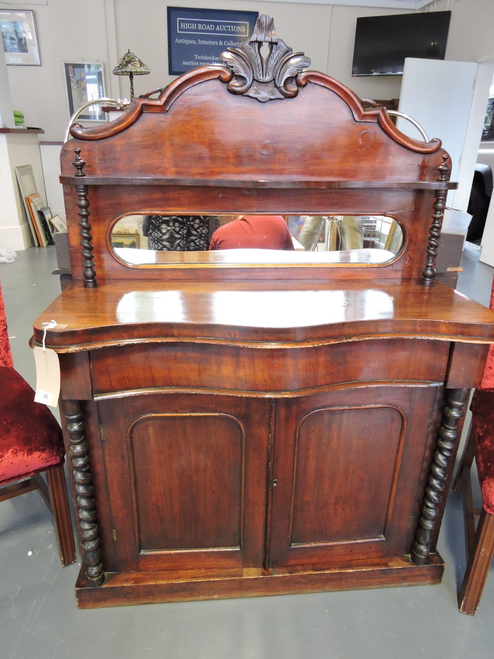 A late Victorian mahogany choffonier, the raised mirrored back with shelf above a serpentine top and