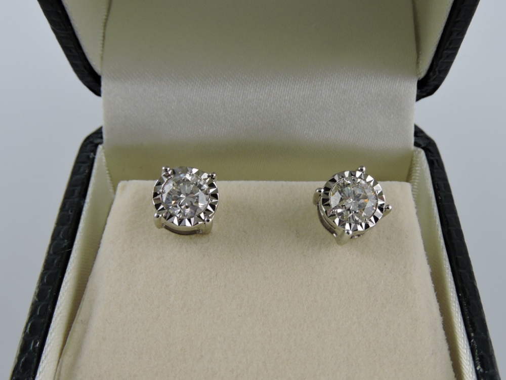 A pair of diamond solitaire ear studs, in 18ct white gold claw mounts, with screw backs, 1.41cts.