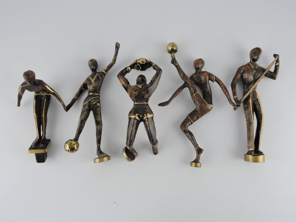 Five 20th Century cast brass and patinated sporting trophy figures in the Art Deco style,