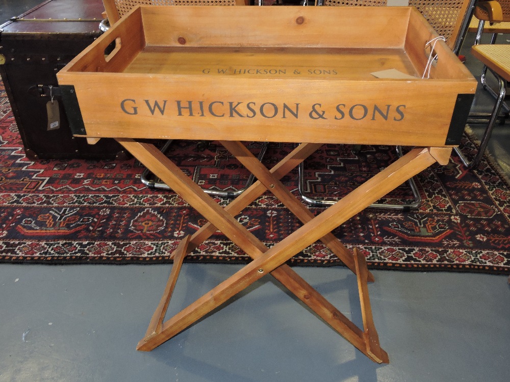 A pine butler's tray on stand, rectangular and stenciled 'G H Hickson & Sons', on a X-form stand, W.