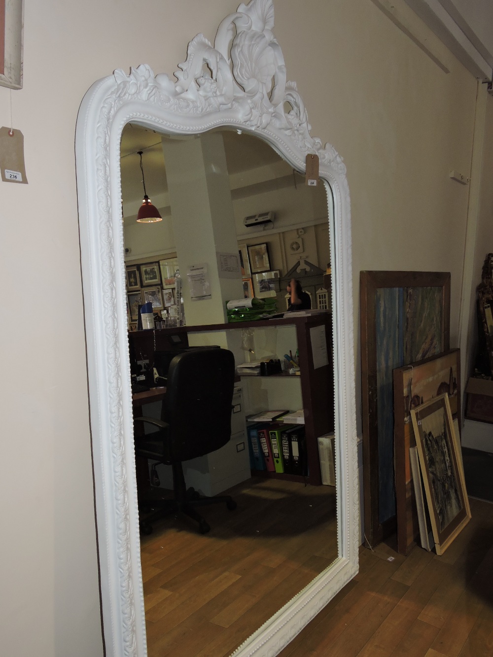 A large Louis XVI design white painted bevelled wall mirror, with pierced-shell and foliate-scroll