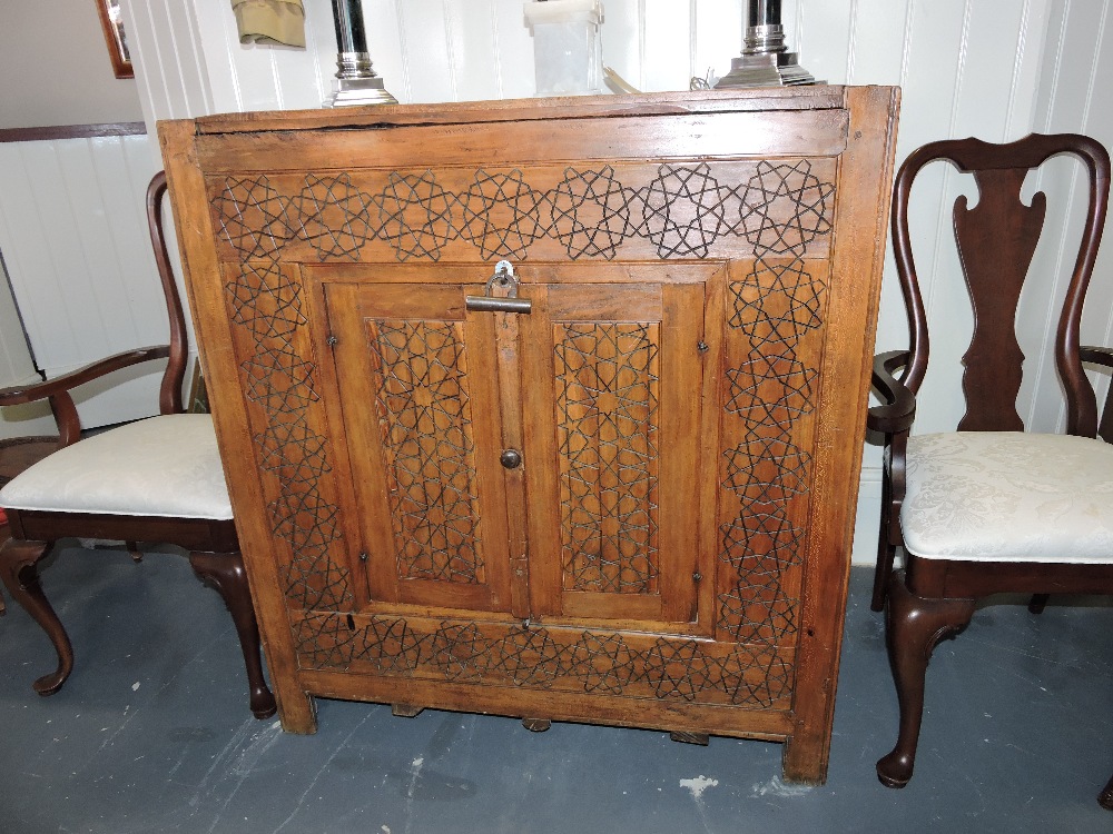An early 20th century Korean hardwood hutch or marriage cabinet, with iron studwork, geometric