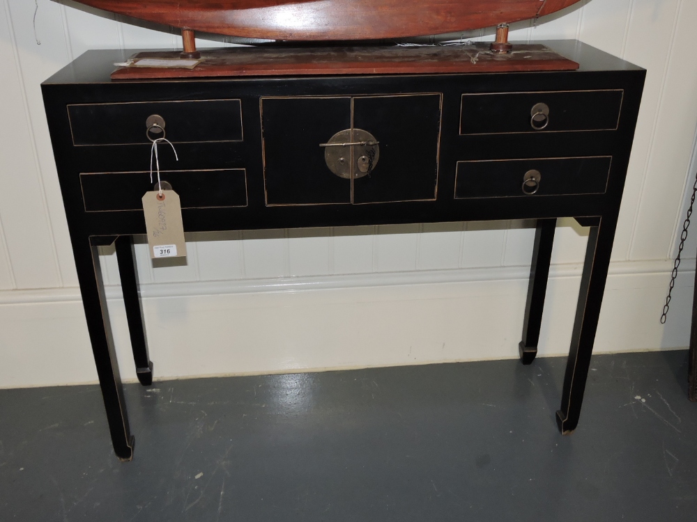 A Chinese style ebonised console table, fitted four drawers around a central cupboard, W. 96cm.