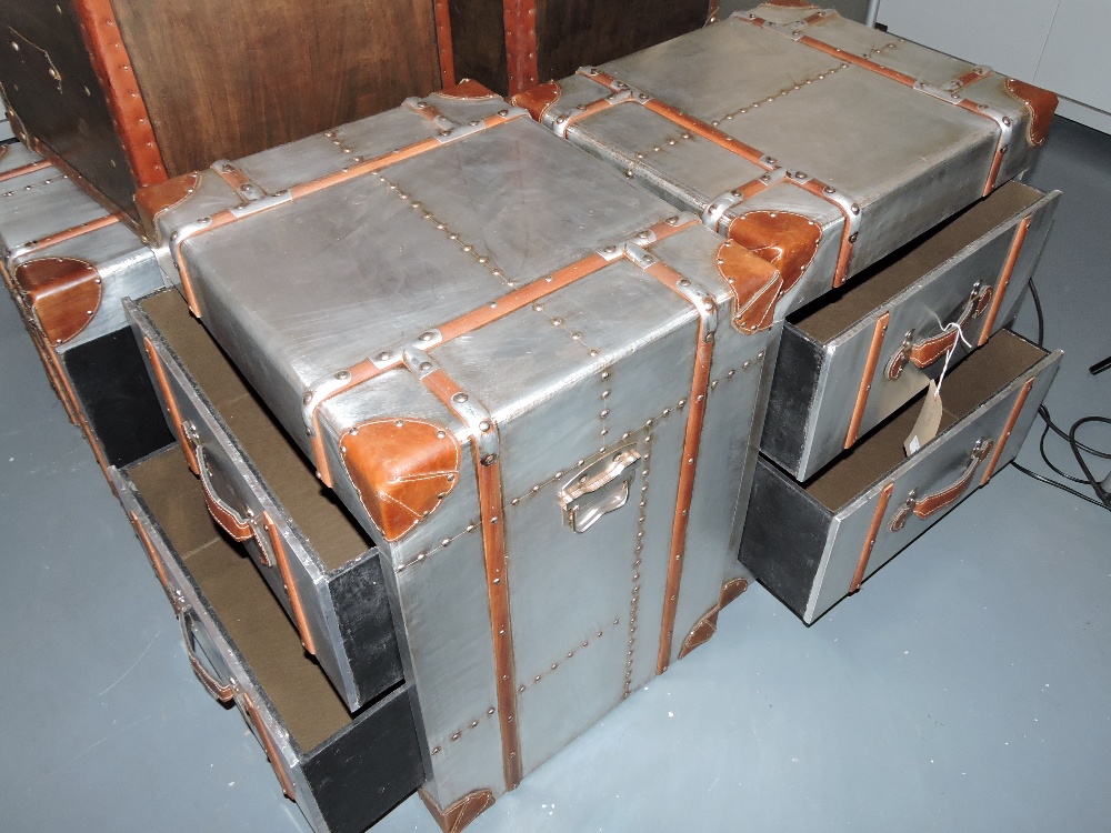 A pair of aluminium Aviator style chests of drawers, square with leather corners and wooden banding,