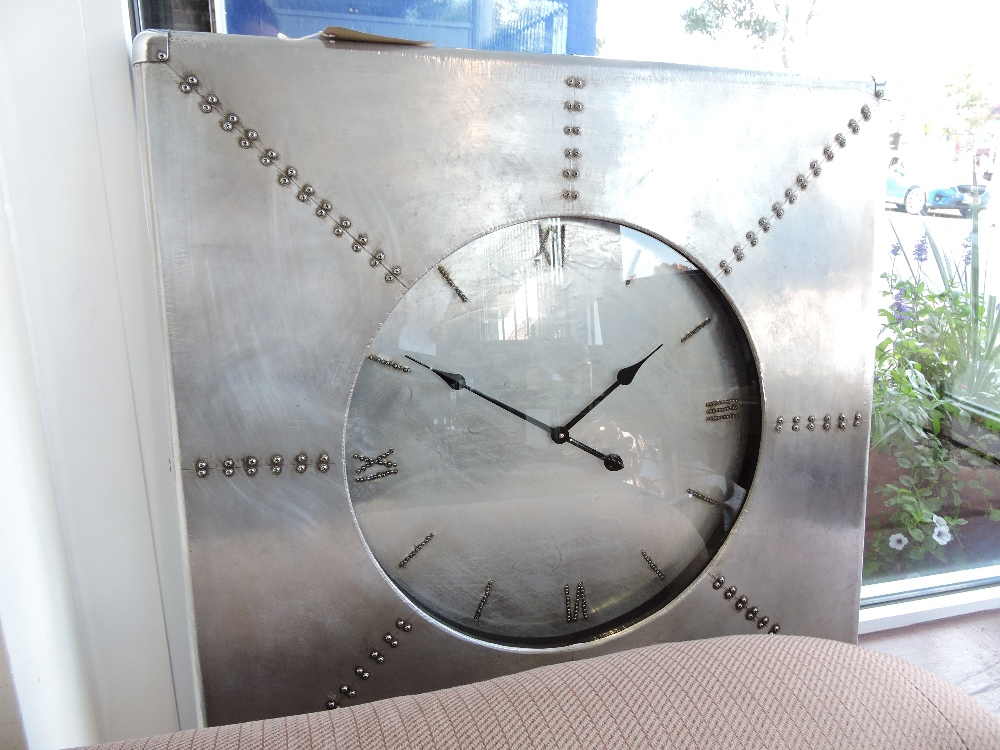 A large square aluminium clad wall clock, W. 92cm