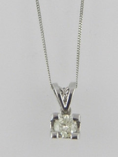 An 18 carat white gold and diamond pendant, the diamond of approx. 0.24 carats, suspended on a