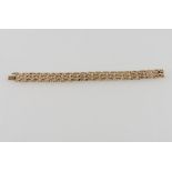 A 9ct gold bracelet of rusticated gate links, 31g.