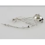 A cast 925 silver pillbox modelled as a skull, on elongated and fine link chain with bar and claw