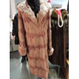 A Russian lilac dyed squirrel fur coat, c.1940, with shawl collar and upturned cuffs, silk lined.