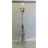 A Victorian wrought iron and copper adjustable standard lamp, converted for electricity,