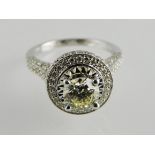 An 18ct white gold diamond cluster ring, with fine high claw set stone with diamond set collar and