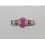 A white metal, diamond and ruby ring.