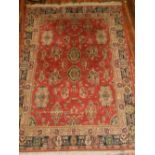 A Persian style red ground carpet, havin