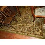 A green ground Persian style carpet, the