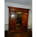 A late Victorian walnut triple wardrobe