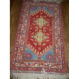 A red and blue ground Caucasian rug, wit