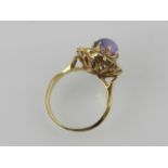 A yellow metal amethyst and diamond set