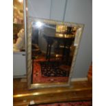 A gilt framed wall mirror.