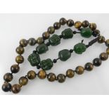 A tiger eye beaded necklace, together wi