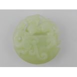 A Chinese jade pendant, depicting a drag