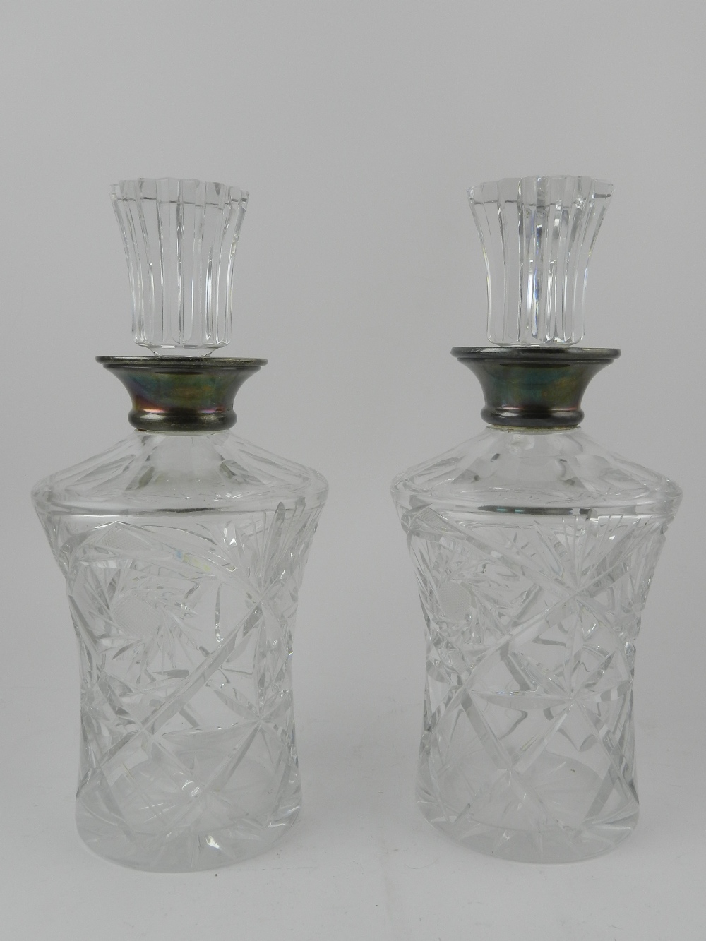 A pair of cut glass decanters with stopp