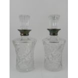 A pair of cut glass decanters with stopp