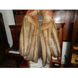 A ladies half length fur coat, having br