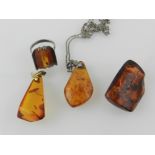 An amber pear shaped amber pendant on a