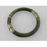 A jade bangle having silver joints. Inte