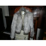 DKNY, New York. A ladies grey rabbit fur