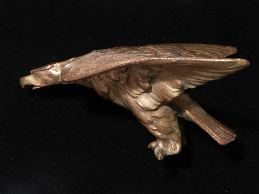 An early 20th century gilt metal car mascot, fashioned as a spread eagle. H:8cm