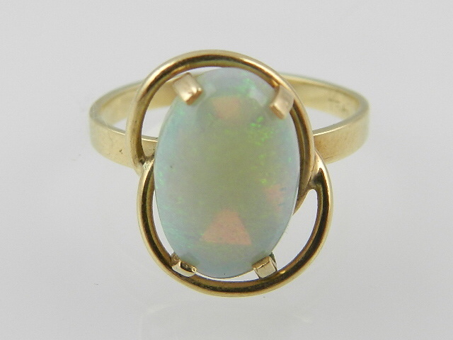 A yellow metal solitaire opal dress ring